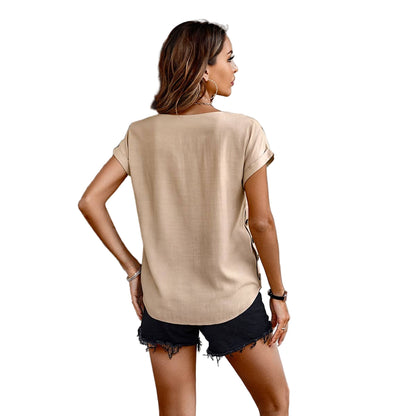 Woman wearing a beige t-shirt and black shorts on a white background